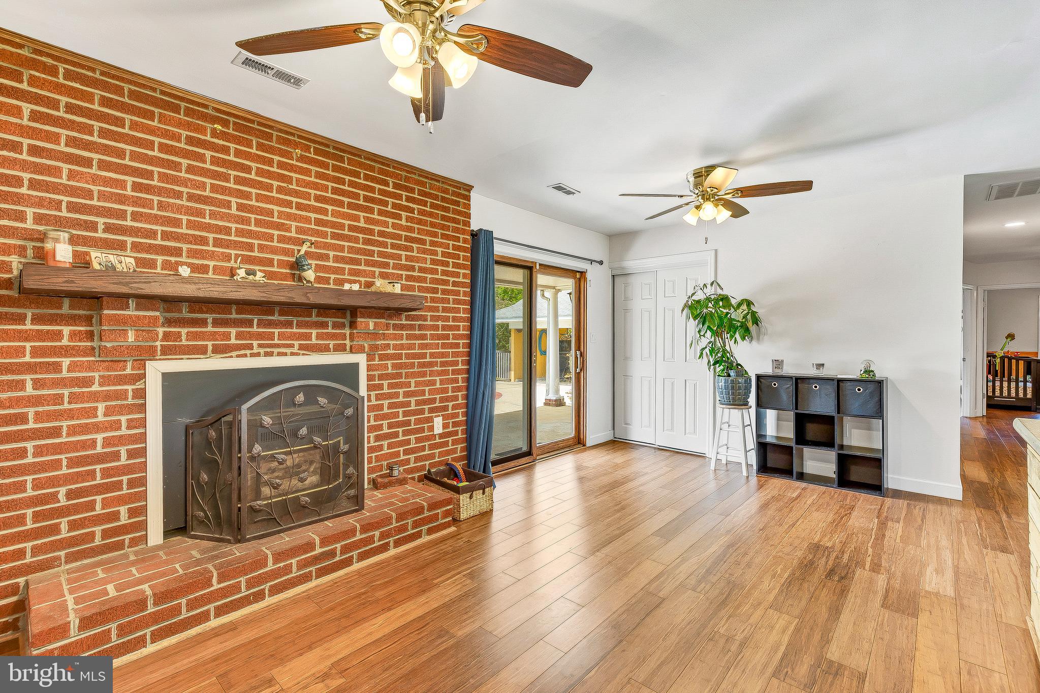 1400 Woods Road St. Leonard, MD 20685 - Photo 17 of 51 Brick accent wall with wood stove
