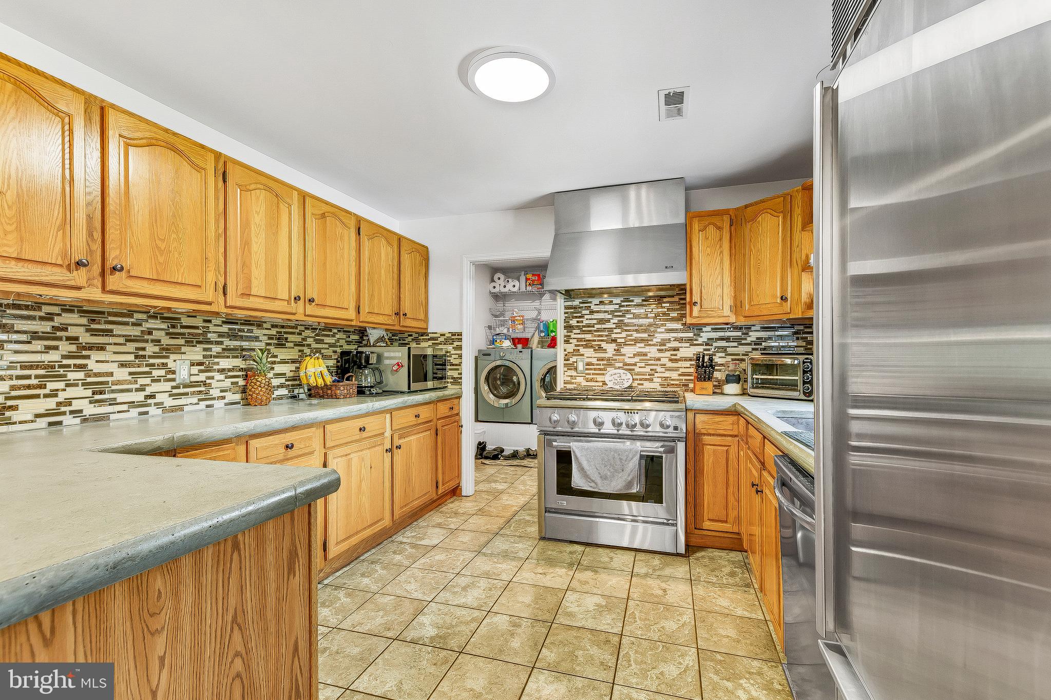 1400 Woods Road St. Leonard, MD 20685 - Photo 19 of 51 Backsplash compliments countertops