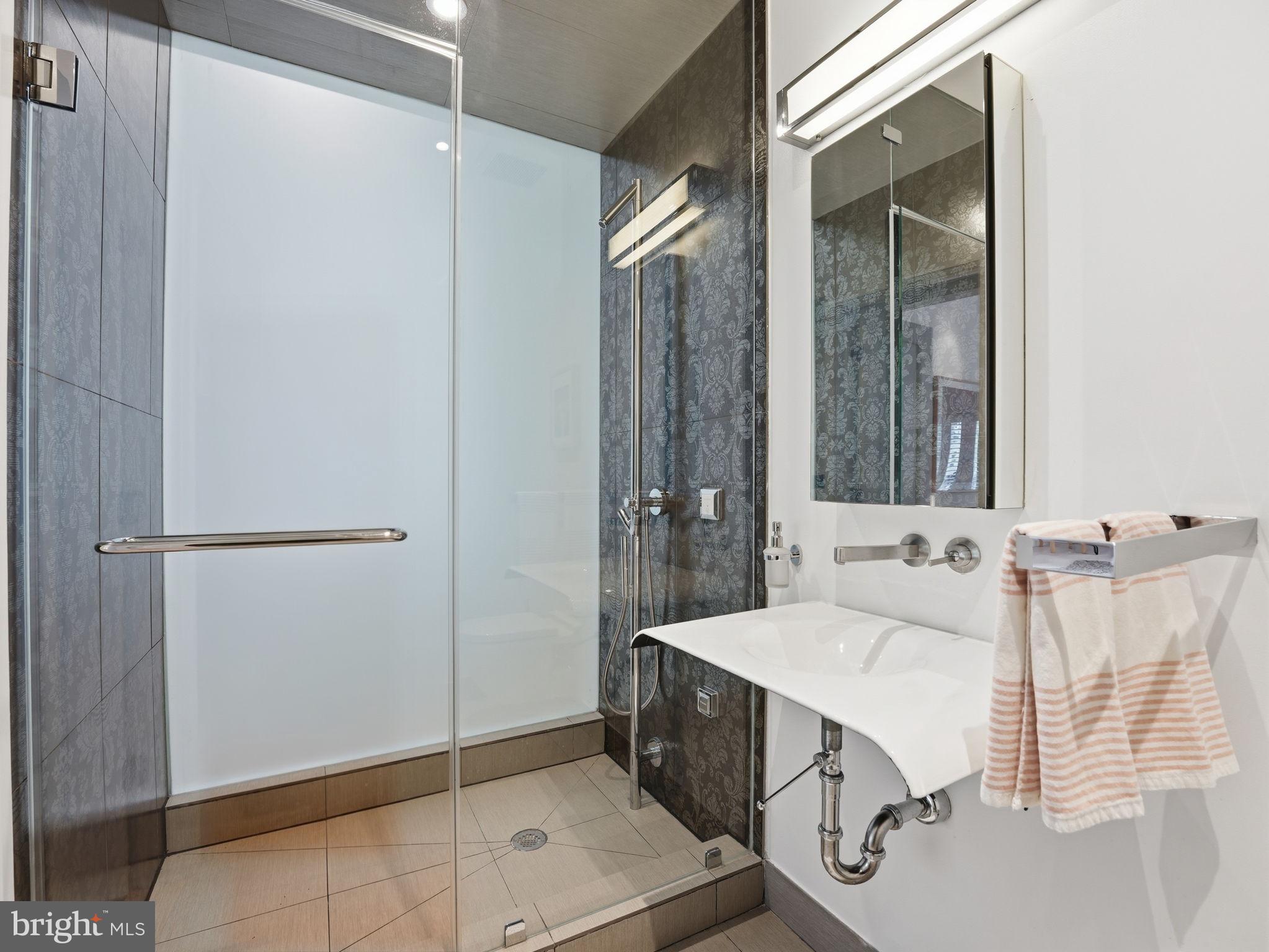 1845 Calvert Street Northwest Washington, DC 20009 - Photo 45 of 48 a bathroom with a double vanity sink and mirror