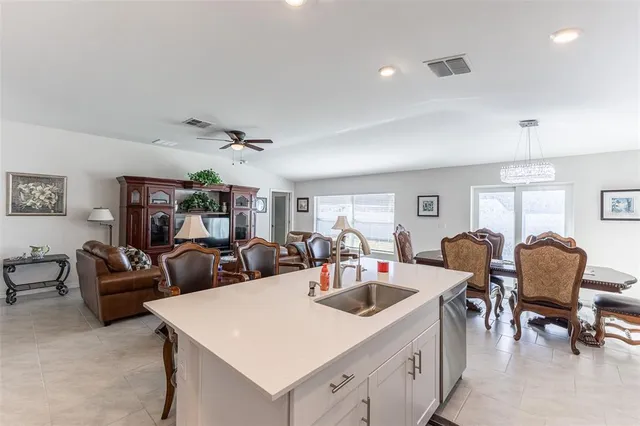 a living room with lots of furniture and kitchen view