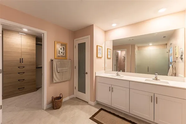 a bathroom with a shower and a glass door