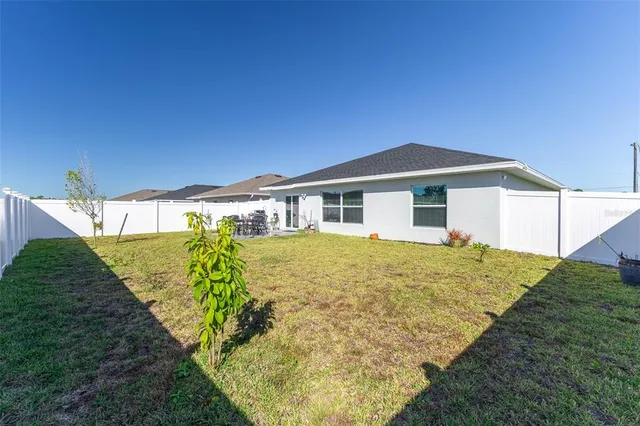 a view of an outdoor dining space with a table and chairs