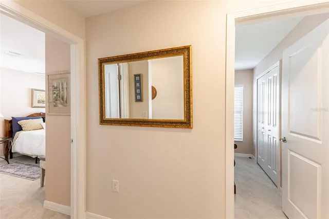 a view of a hallway with furniture and a mirror