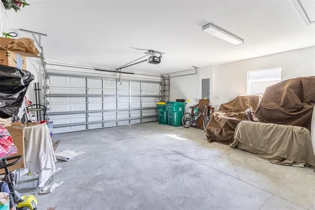 a living room with furniture kitchen view and a window