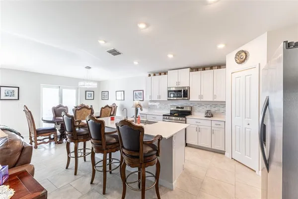 a kitchen with stainless steel appliances granite countertop a refrigerator sink and cabinets