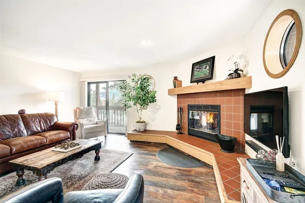 a living room with furniture a flat screen tv and a fireplace