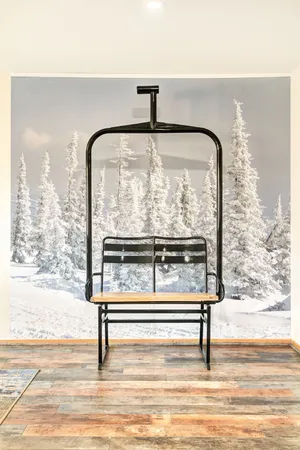 a view of empty room with wooden floor and floor to ceiling window