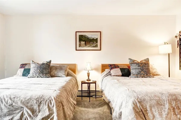 a bedroom with a bed and a lamp