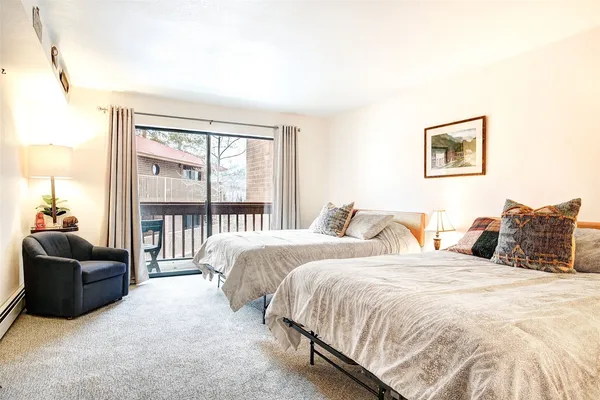 a bed room with two bed and a couch