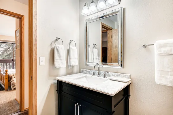 a bathroom with a sink vanity and a mirror