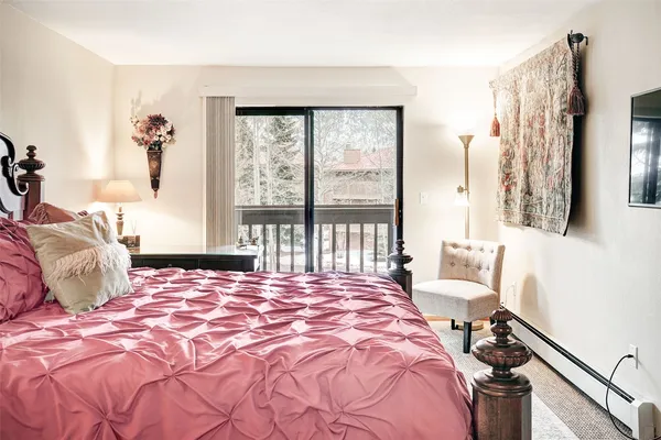 a bedroom with a bed and a large window