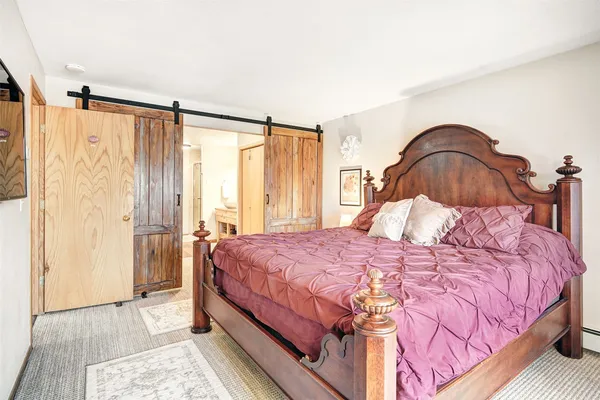 a bedroom with a bed and a mirror