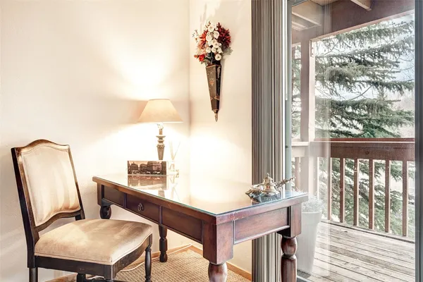 a room with a table chairs and wooden floor