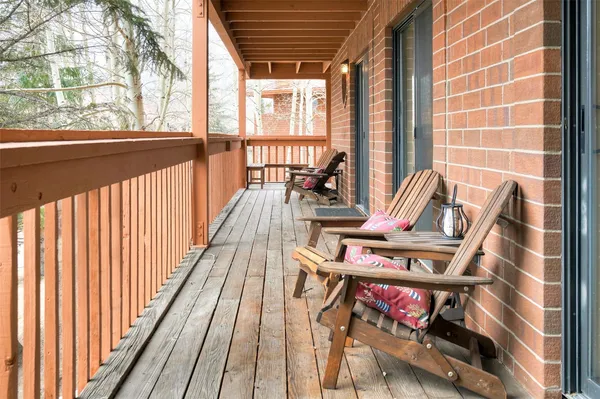 a view of balcony with wooden floor and outdoor seating