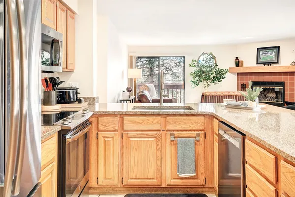 a kitchen with stainless steel appliances granite countertop a stove and a sink