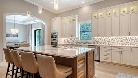 a kitchen with center island table and chairs