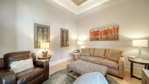 a living room with furniture and a night stand