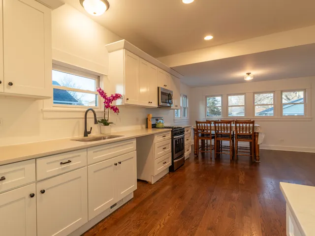 a kitchen with sink cabinets and wooden floor