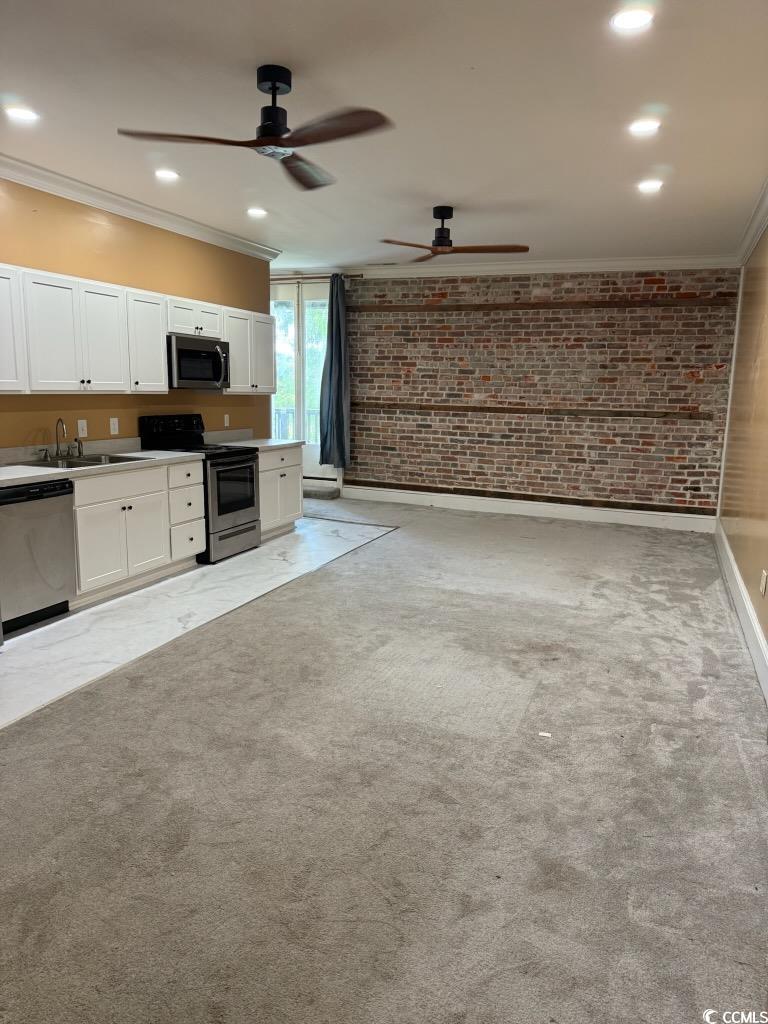801 Front Street, Unit APARTMENT C Georgetown, SC 29440 - Photo 3 of 8 Unfurnished living room with brick wall, light col
