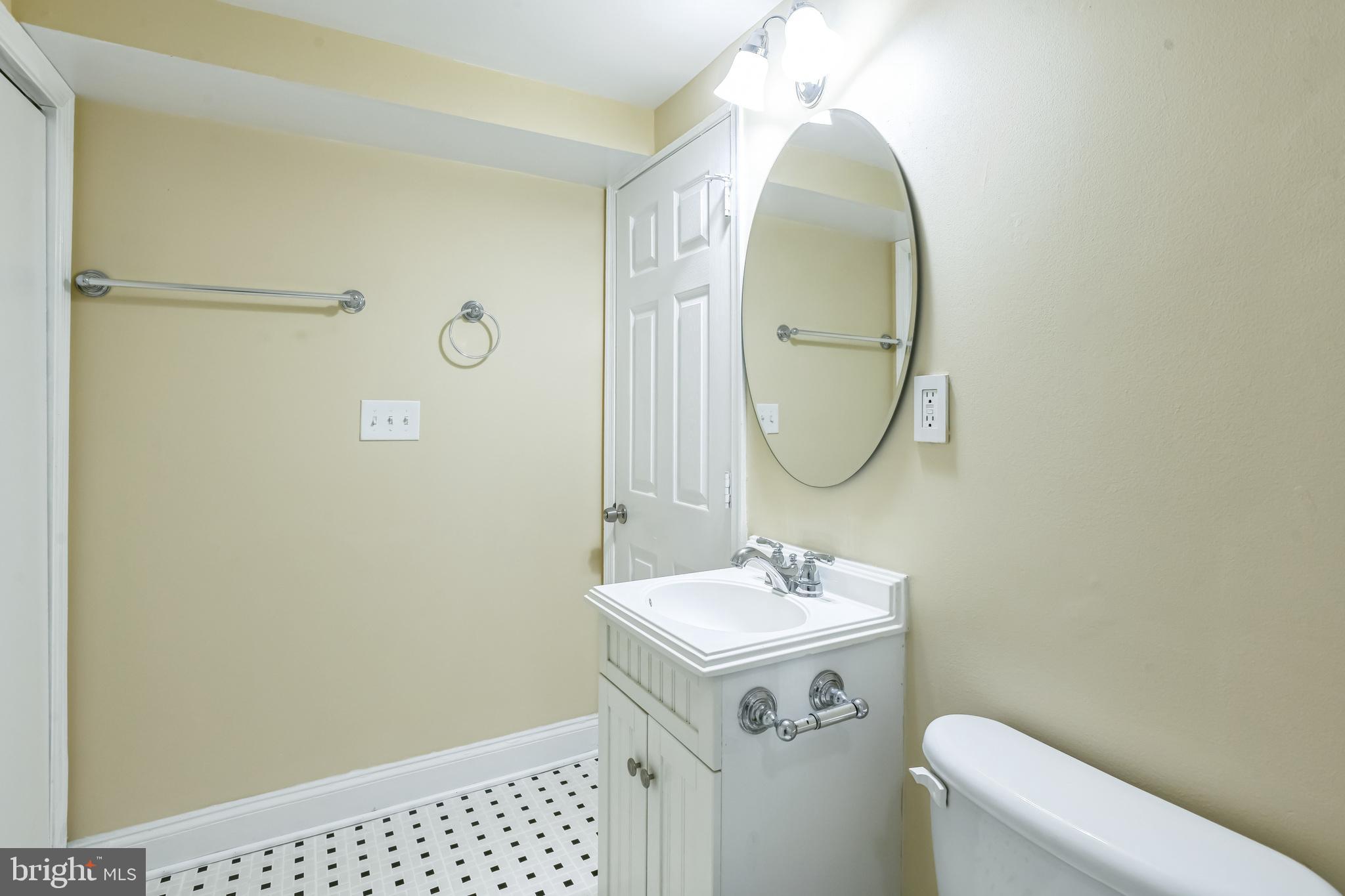 129 North Duncan Street Baltimore, MD 21231 - Photo 21 of 34 a bathroom with a sink a toilet and a mirror