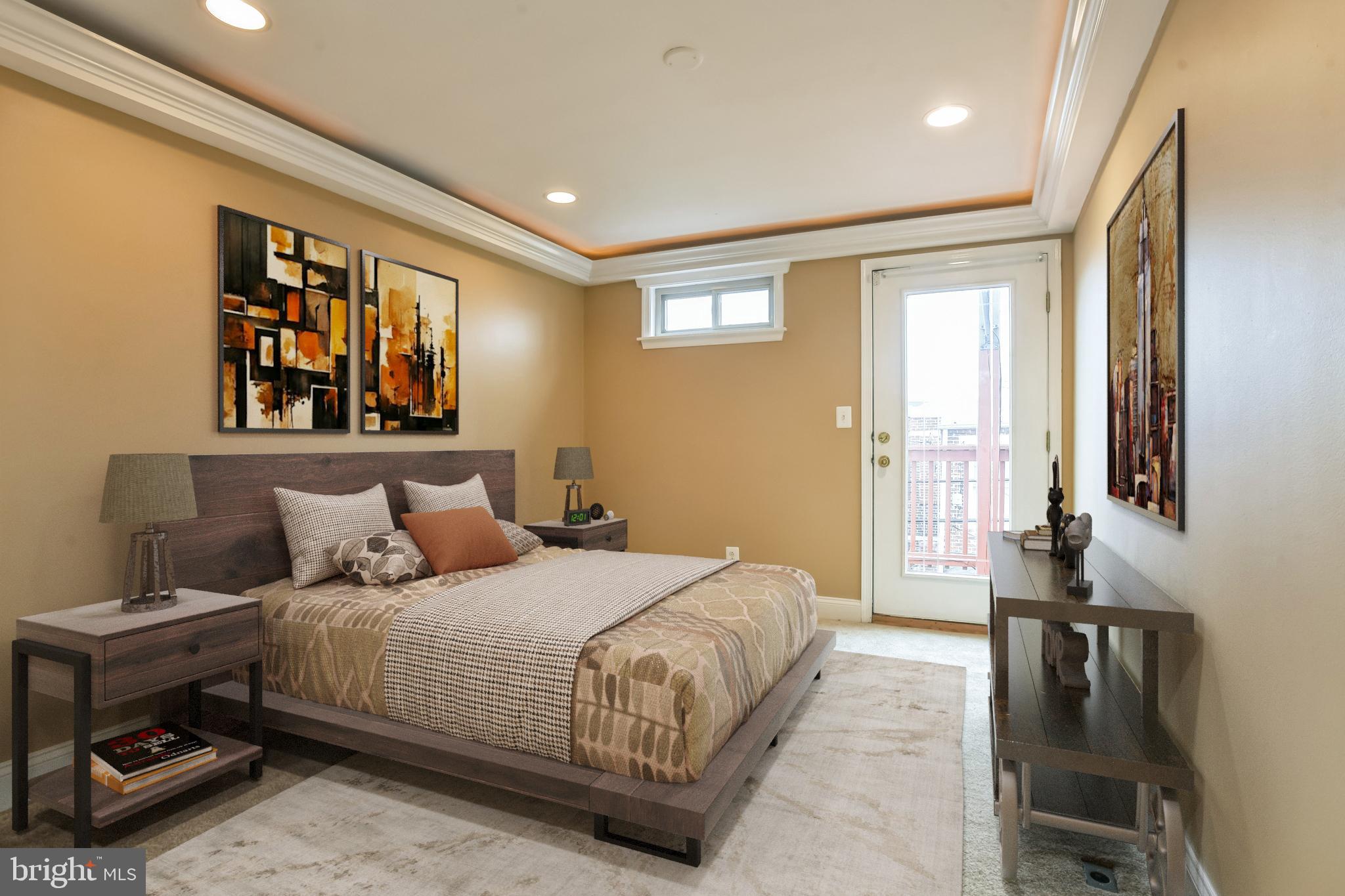 129 North Duncan Street Baltimore, MD 21231 - Photo 29 of 34 a bedroom with a large bed and a window