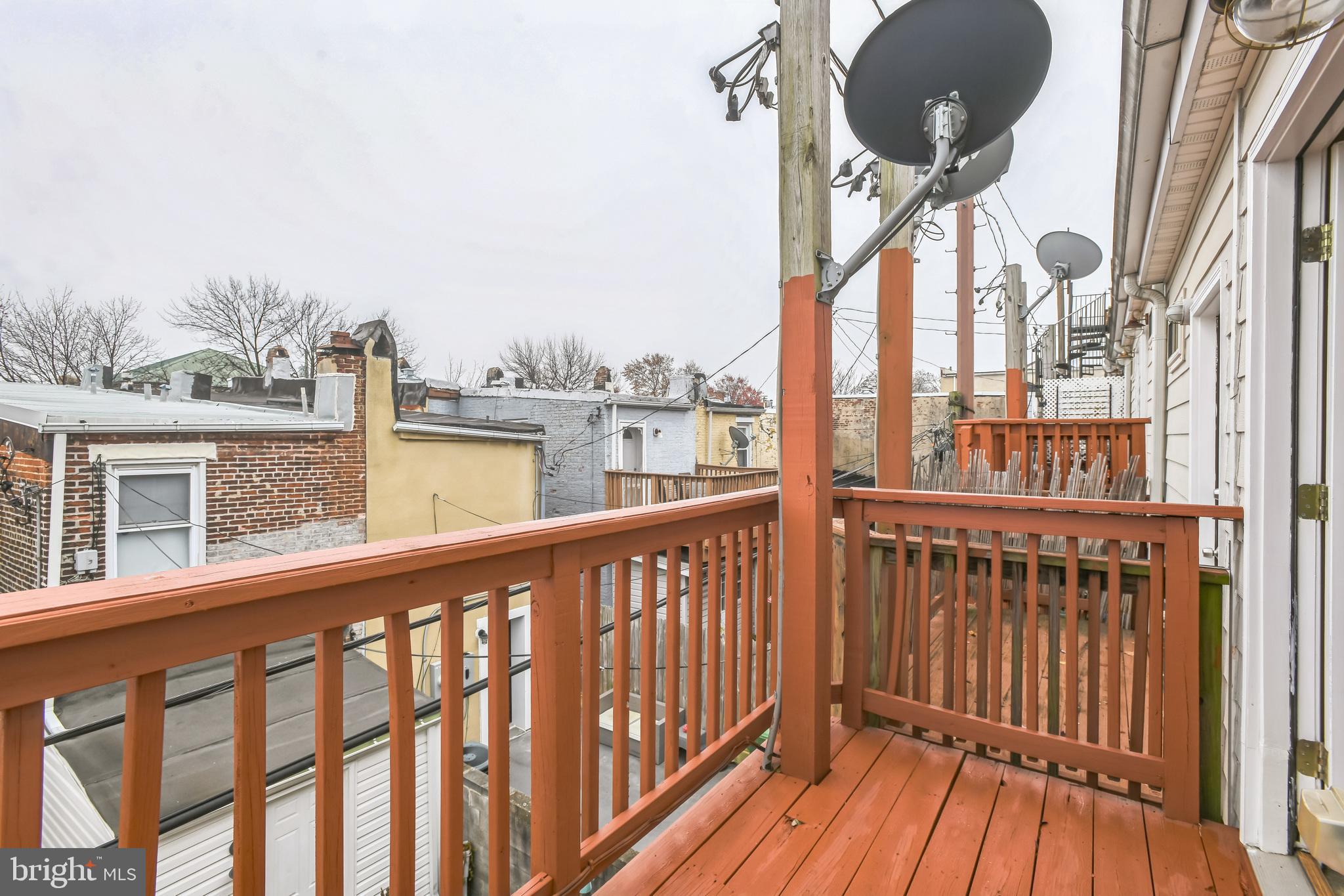129 North Duncan Street Baltimore, MD 21231 - Photo 32 of 34 a view of a balcony with wooden floor and fence