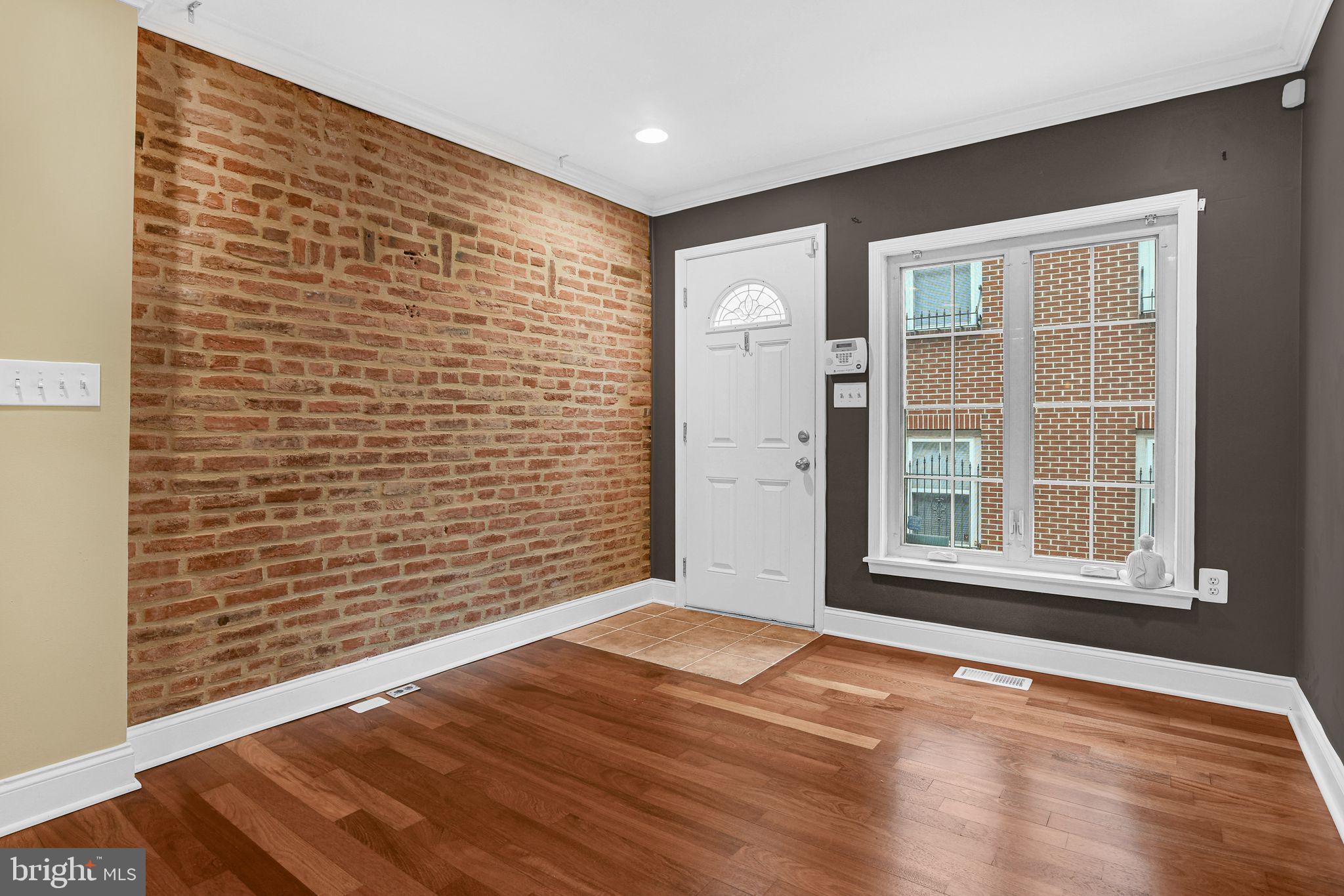 129 North Duncan Street Baltimore, MD 21231 - Photo 4 of 34 an empty room with wooden floor and windows