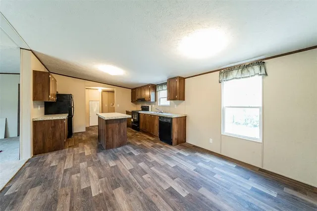 a kitchen with stainless steel appliances a refrigerator sink and cabinets