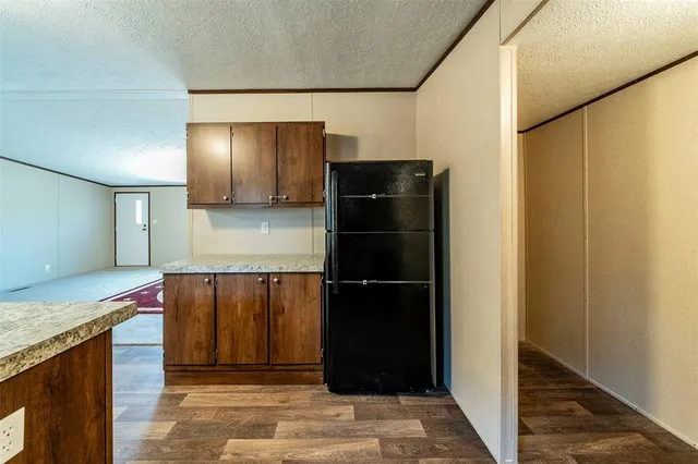 a kitchen with a refrigerator and a sink