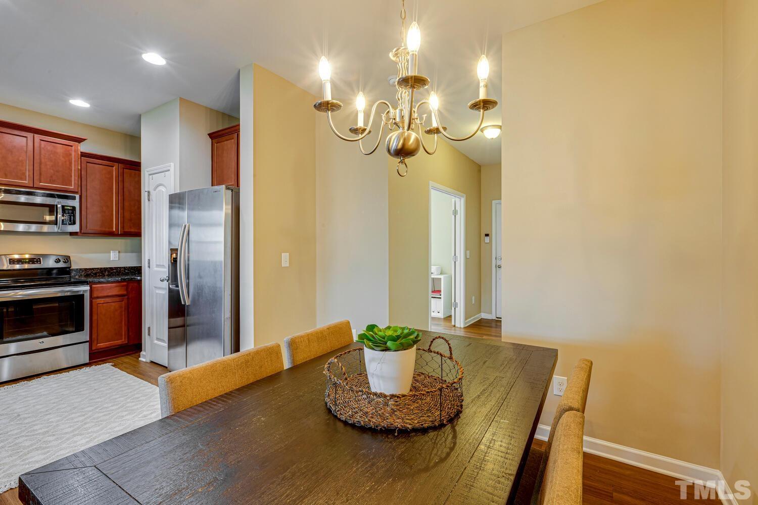 2416 Savior Street Raleigh, NC 27610 - Photo 11 of 47 a kitchen with a table and stainless steel appliances