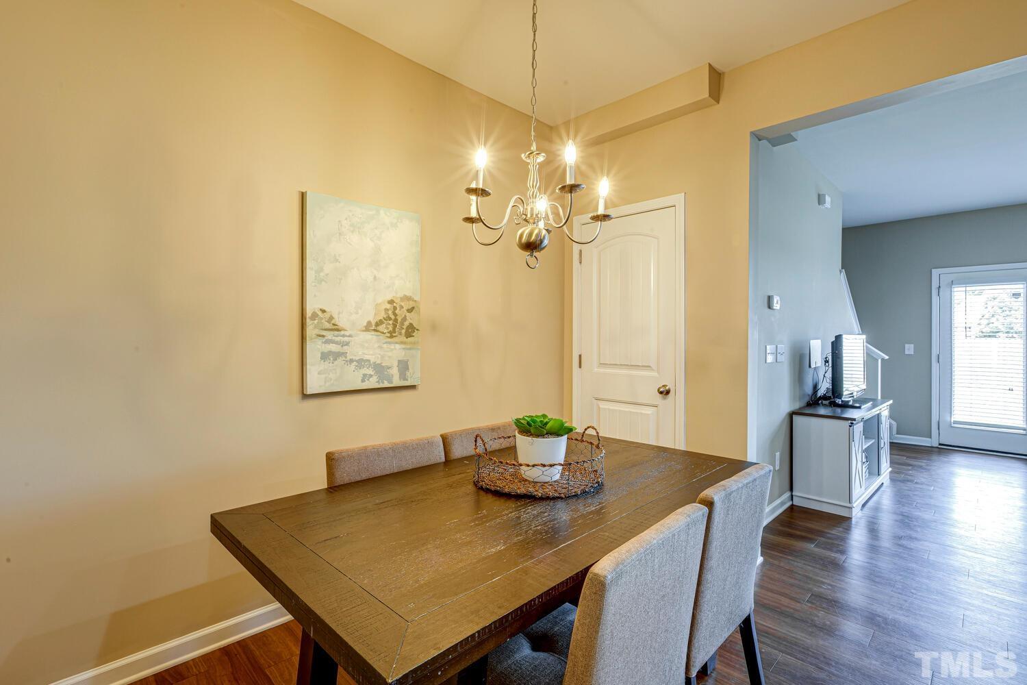 2416 Savior Street Raleigh, NC 27610 - Photo 13 of 47 a view of a dining room with furniture and wooden floor