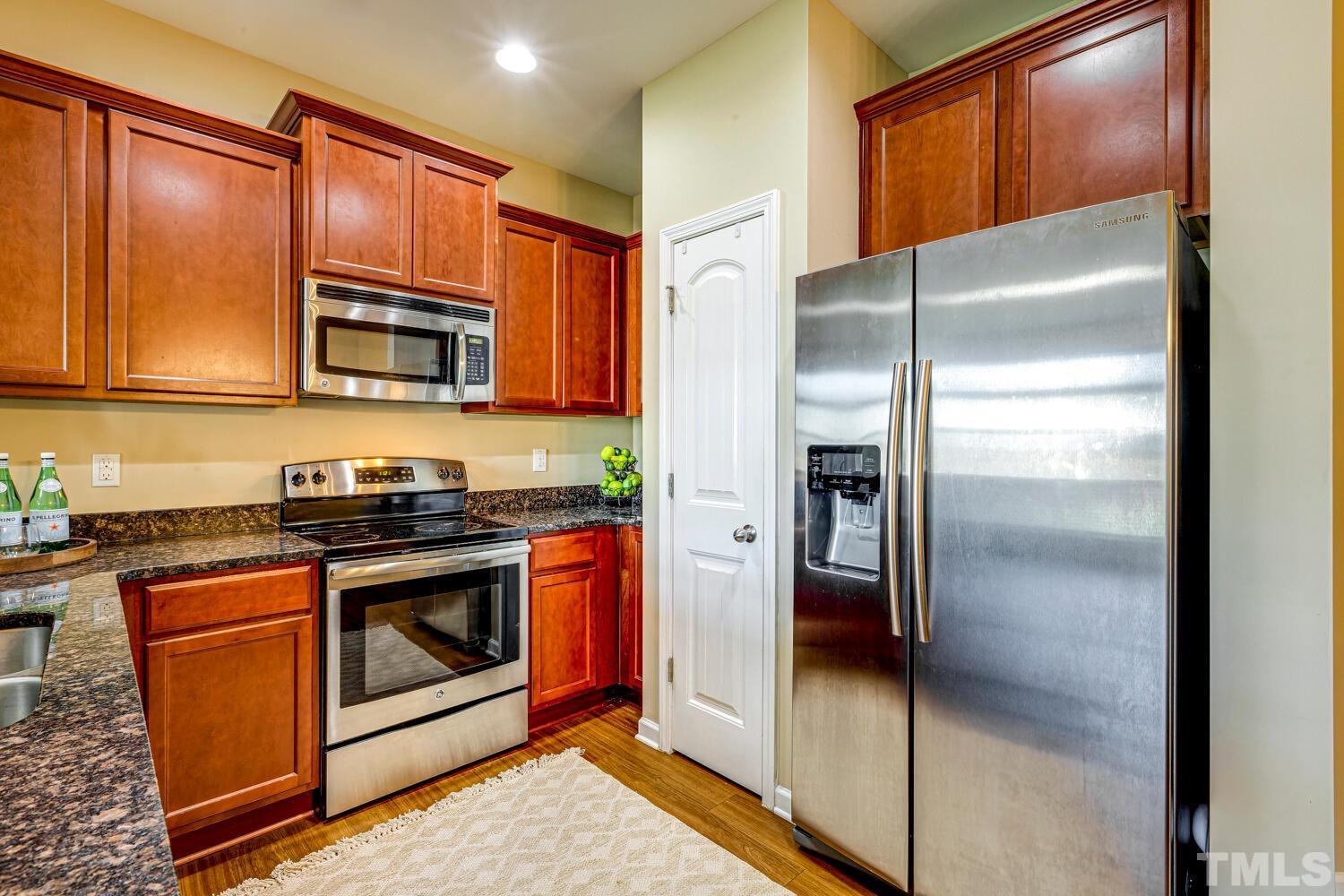 2416 Savior Street Raleigh, NC 27610 - Photo 15 of 47 a kitchen with stainless steel appliances granite countertop a refrigerator and a stove top oven