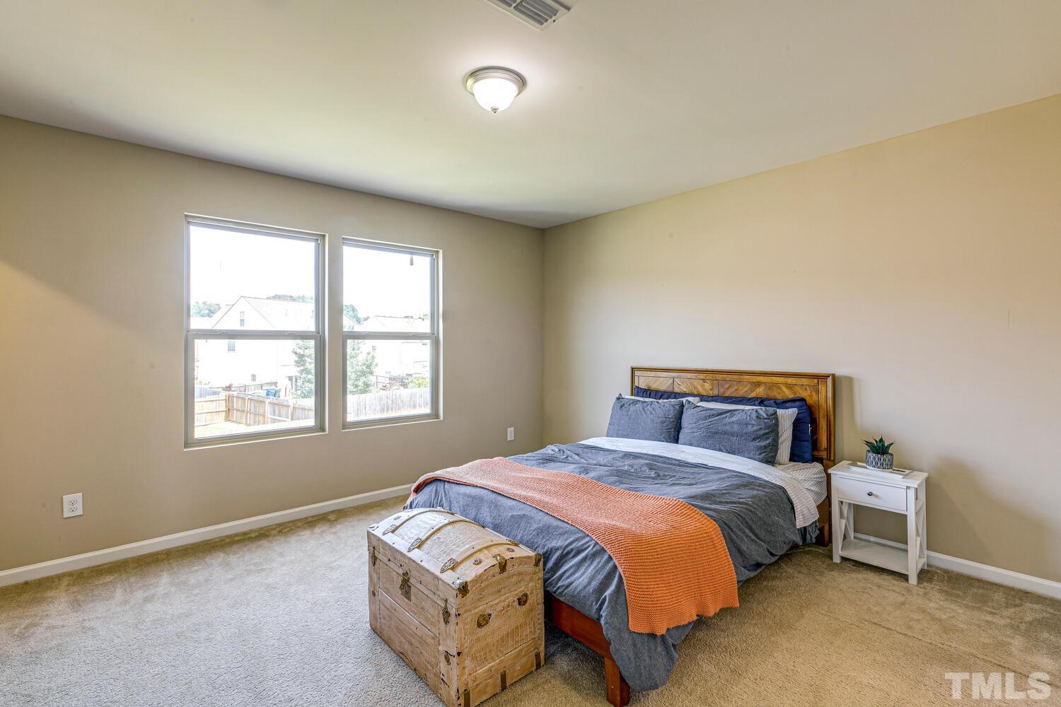 2416 Savior Street Raleigh, NC 27610 - Photo 21 of 47 a bedroom with a bed and a window