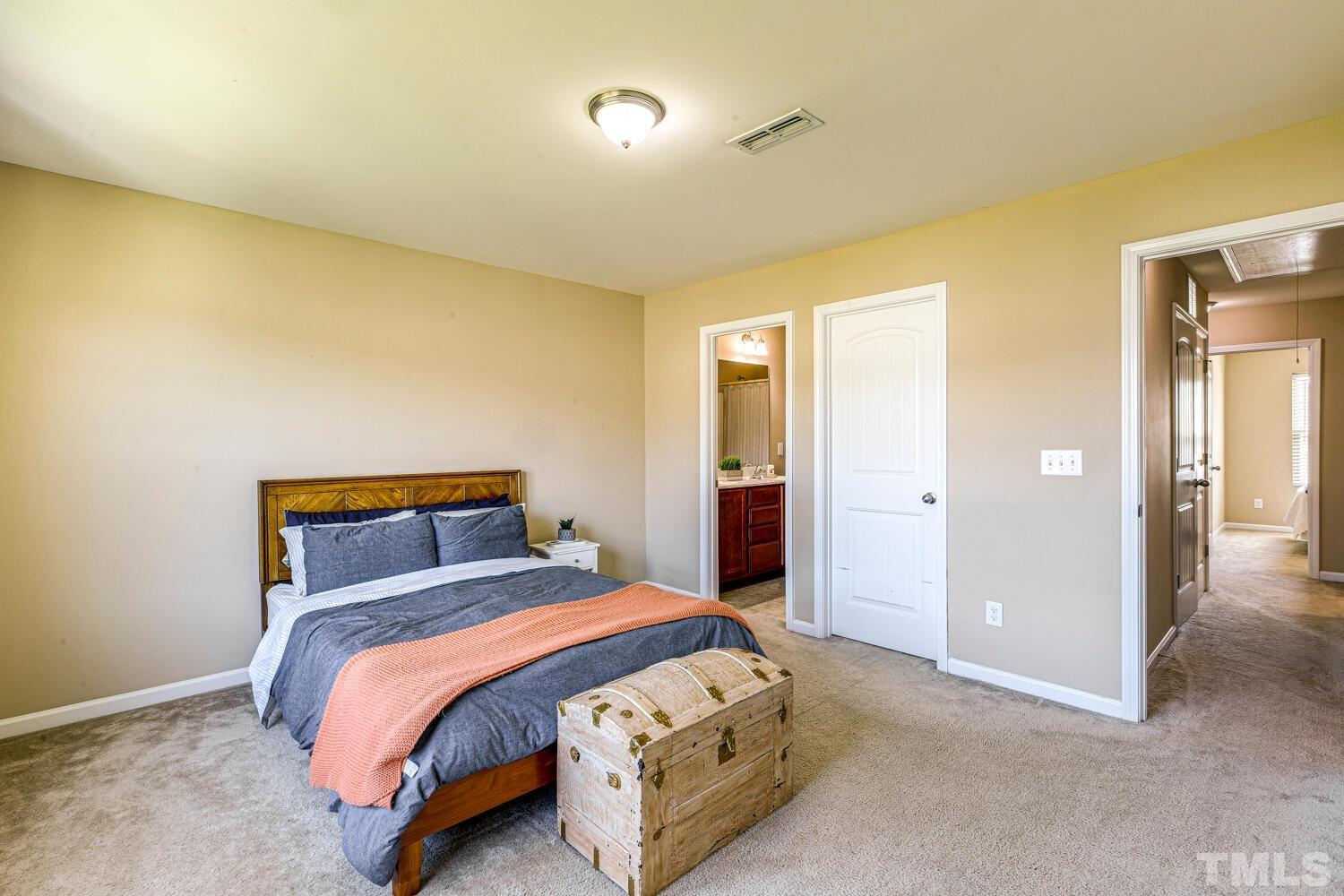 2416 Savior Street Raleigh, NC 27610 - Photo 23 of 47 a bedroom with a bed and painted walls