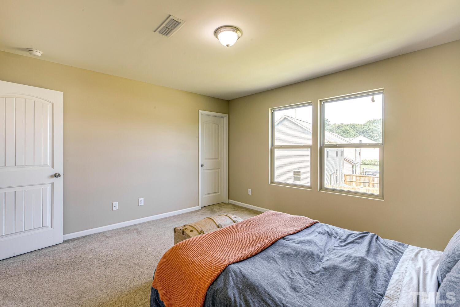 2416 Savior Street Raleigh, NC 27610 - Photo 25 of 47 a bedroom with a bed and a window