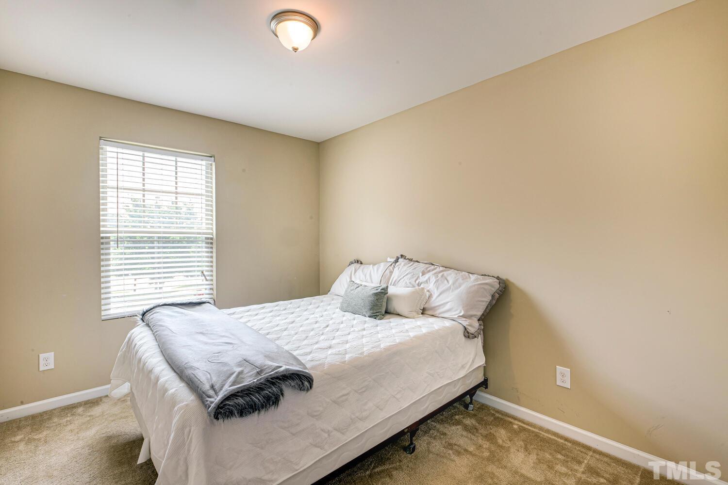 2416 Savior Street Raleigh, NC 27610 - Photo 30 of 47 a bedroom with a bed and a window