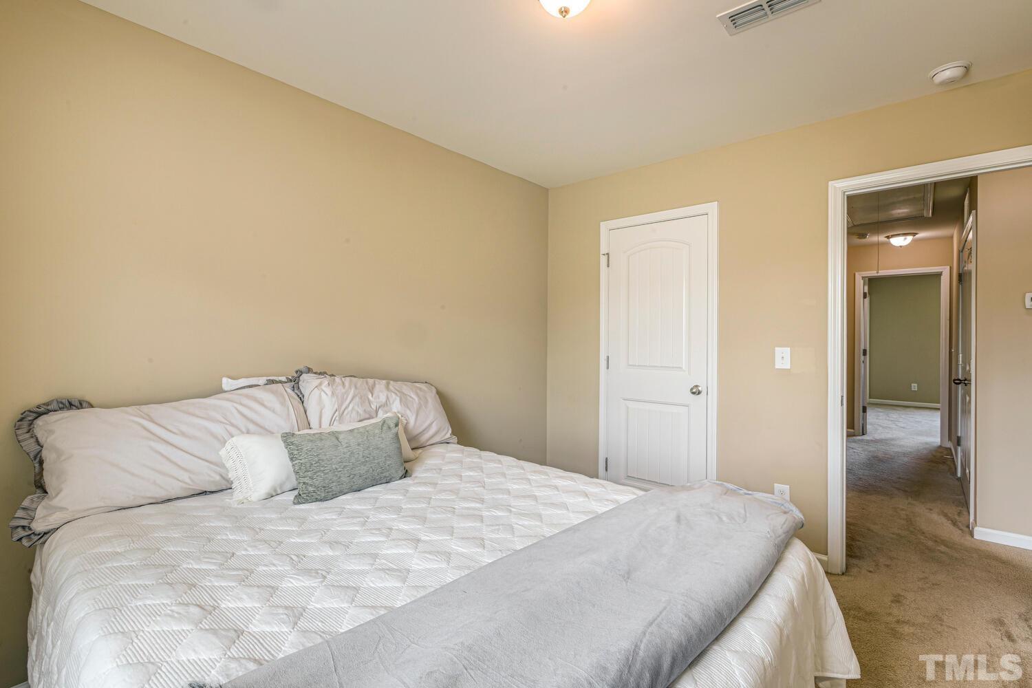 2416 Savior Street Raleigh, NC 27610 - Photo 31 of 47 a large bed sitting in a bedroom and a bathroom