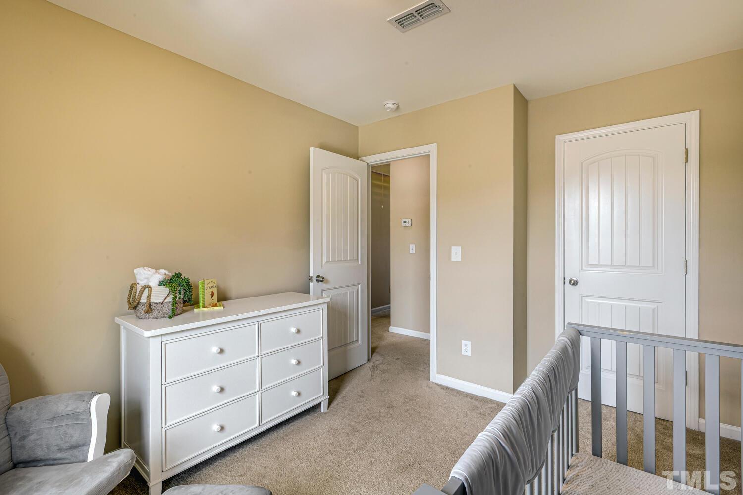 2416 Savior Street Raleigh, NC 27610 - Photo 35 of 47 a room with a bed and a dresser