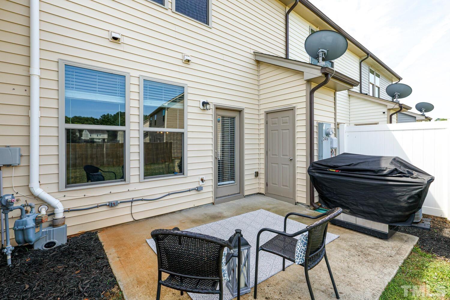 2416 Savior Street Raleigh, NC 27610 - Photo 36 of 47 a view of a patio with table and chairs and wooden floor