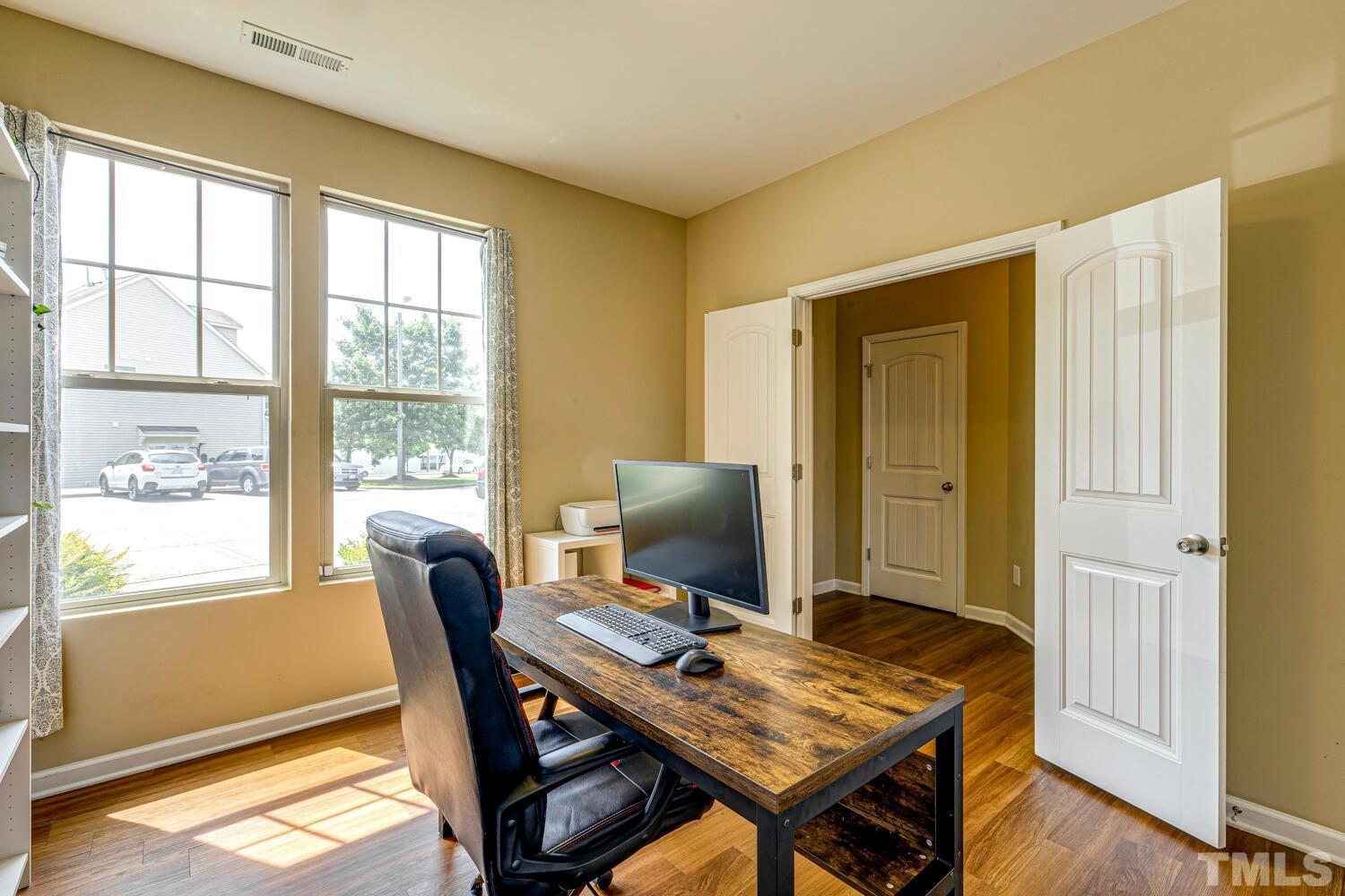 2416 Savior Street Raleigh, NC 27610 - Photo 5 of 47 a view of a workspace with furniture and a window