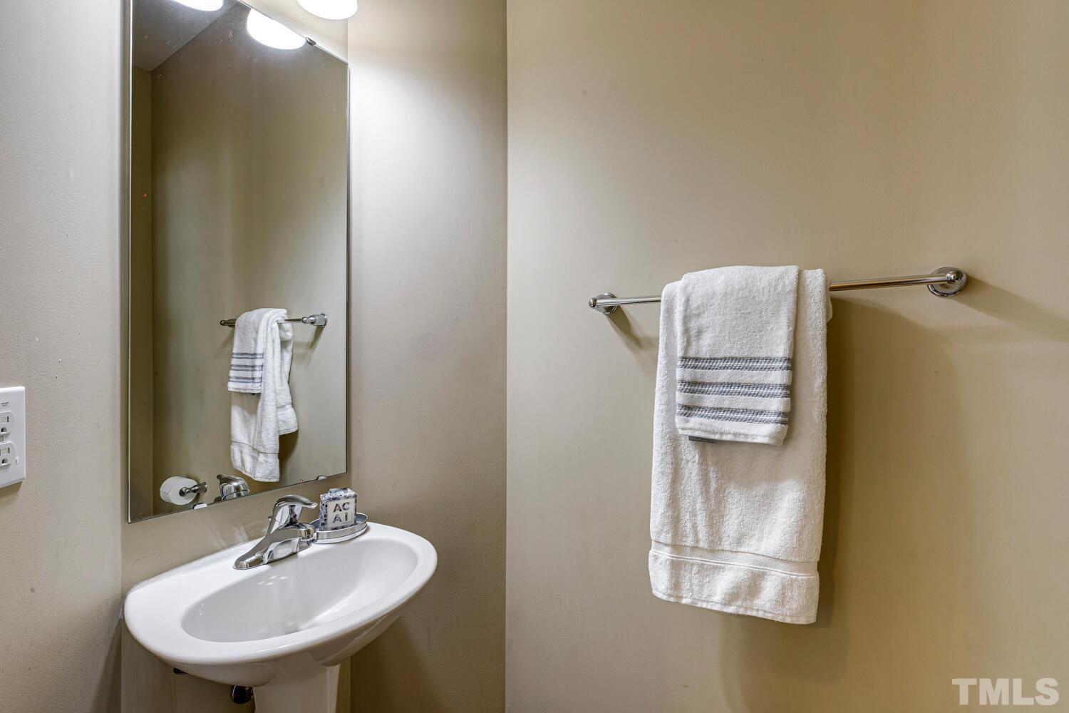 2416 Savior Street Raleigh, NC 27610 - Photo 9 of 47 a bathroom with a sink and mirror