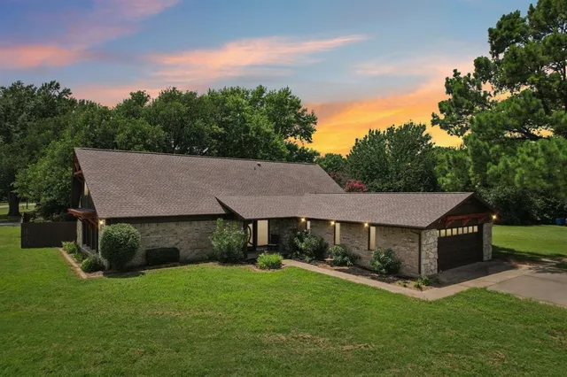 a view of a house with a yard and sitting area
