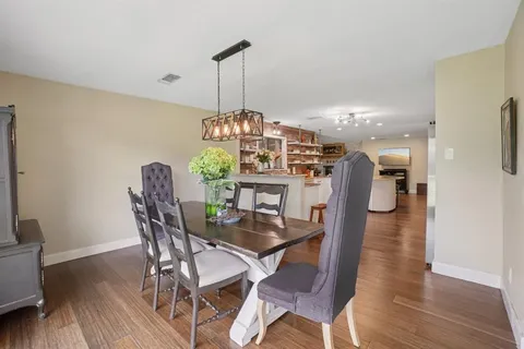 a view of a dining room with furniture wooden floor and chandelier