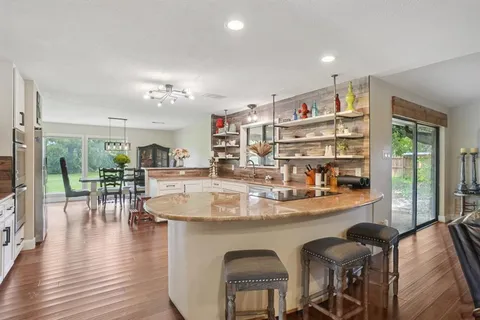 a room with dining table and wooden floor