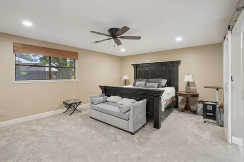 a living room with furniture and a ceiling fan