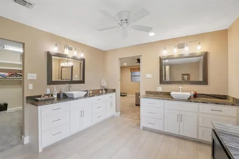 a spacious bathroom with a double vanity sink double and mirror