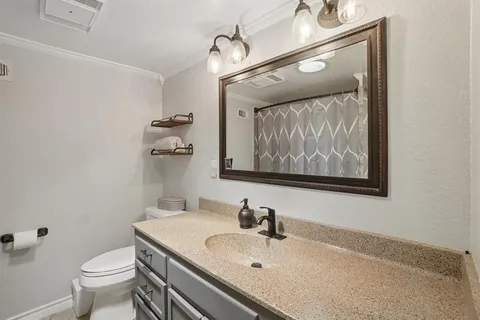 a bathroom with a sink and mirror with toilet