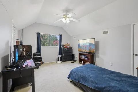a bedroom with a bed and a flat tv screen on closet