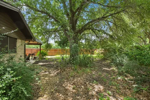 a backyard of a house with a yard and outdoor seating