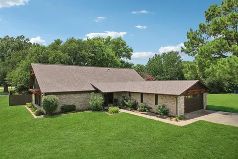 a aerial view of a house with a yard table and chairs